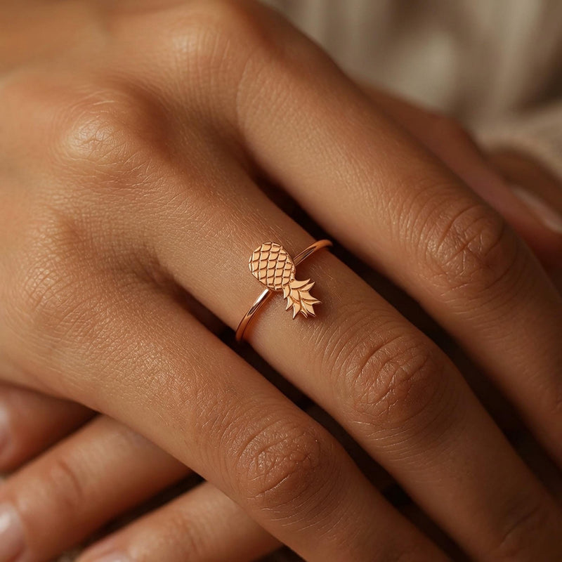 Thin gold ring with a small pineapple sitting on the crown of the band. (5 of 8)