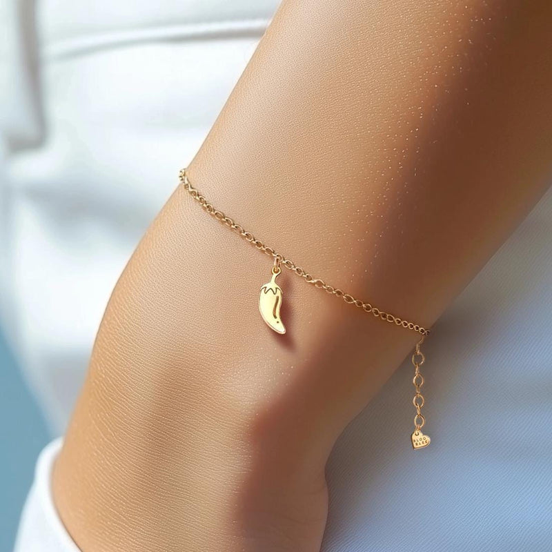 Tiny gold chili pepper charm with curved body and hooked stem on a chain bracelet (11 of 12)