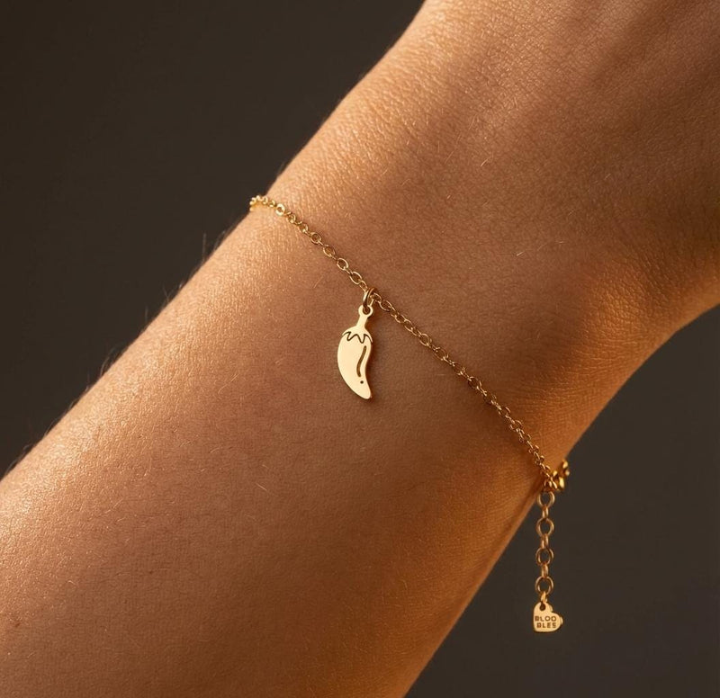 Tiny gold chili pepper charm with curved body and hooked stem on a chain bracelet (2 of 12)