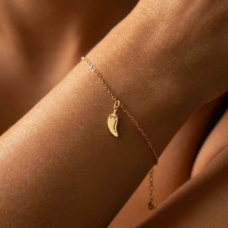 Tiny gold chili pepper charm with curved body and hooked stem on a chain bracelet (6 of 12)