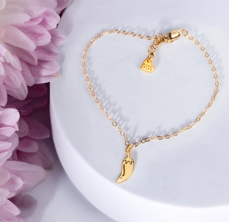 Tiny gold chili pepper charm with curved body and hooked stem on a chain bracelet (7 of 12)