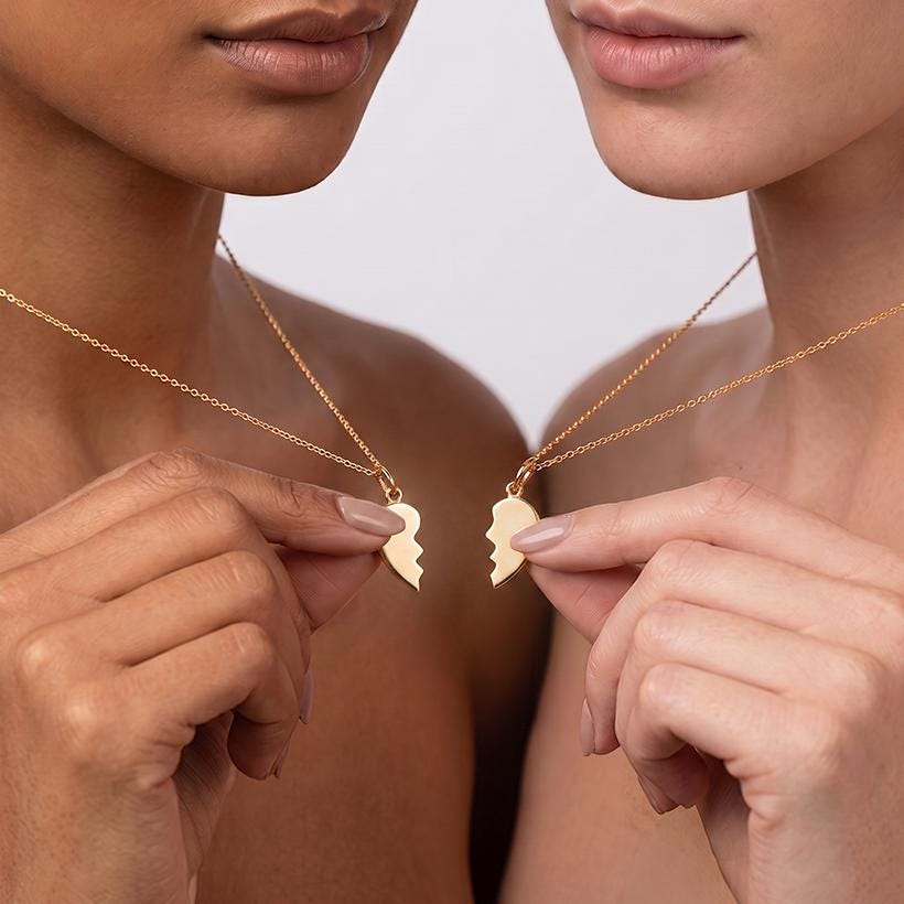 Small gold half heart pendant with a jagged edge on a fine chain