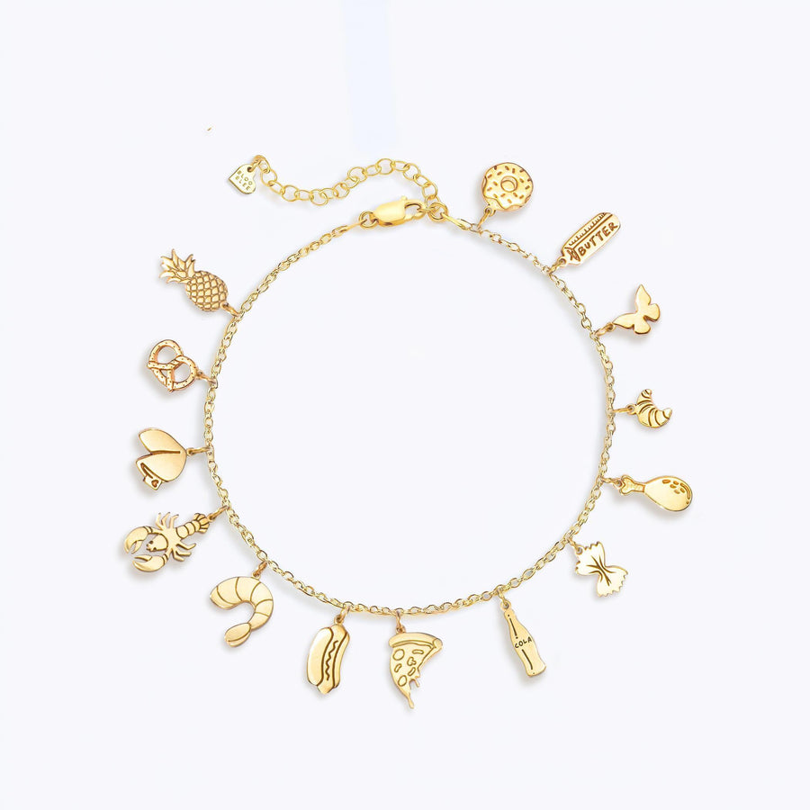 Gold charm bracelet with a mix of tiny charms