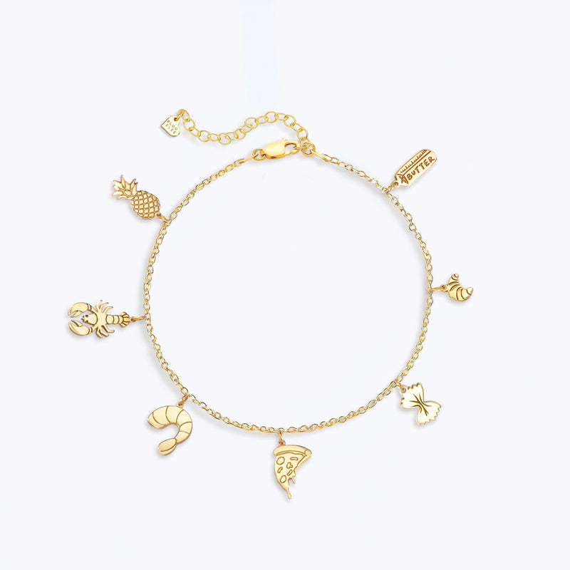 Fine gold chain anklet hung with several tiny gold charms