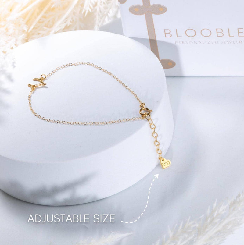 Fine gold chain anklet hung with several tiny gold charms (9 of 12)