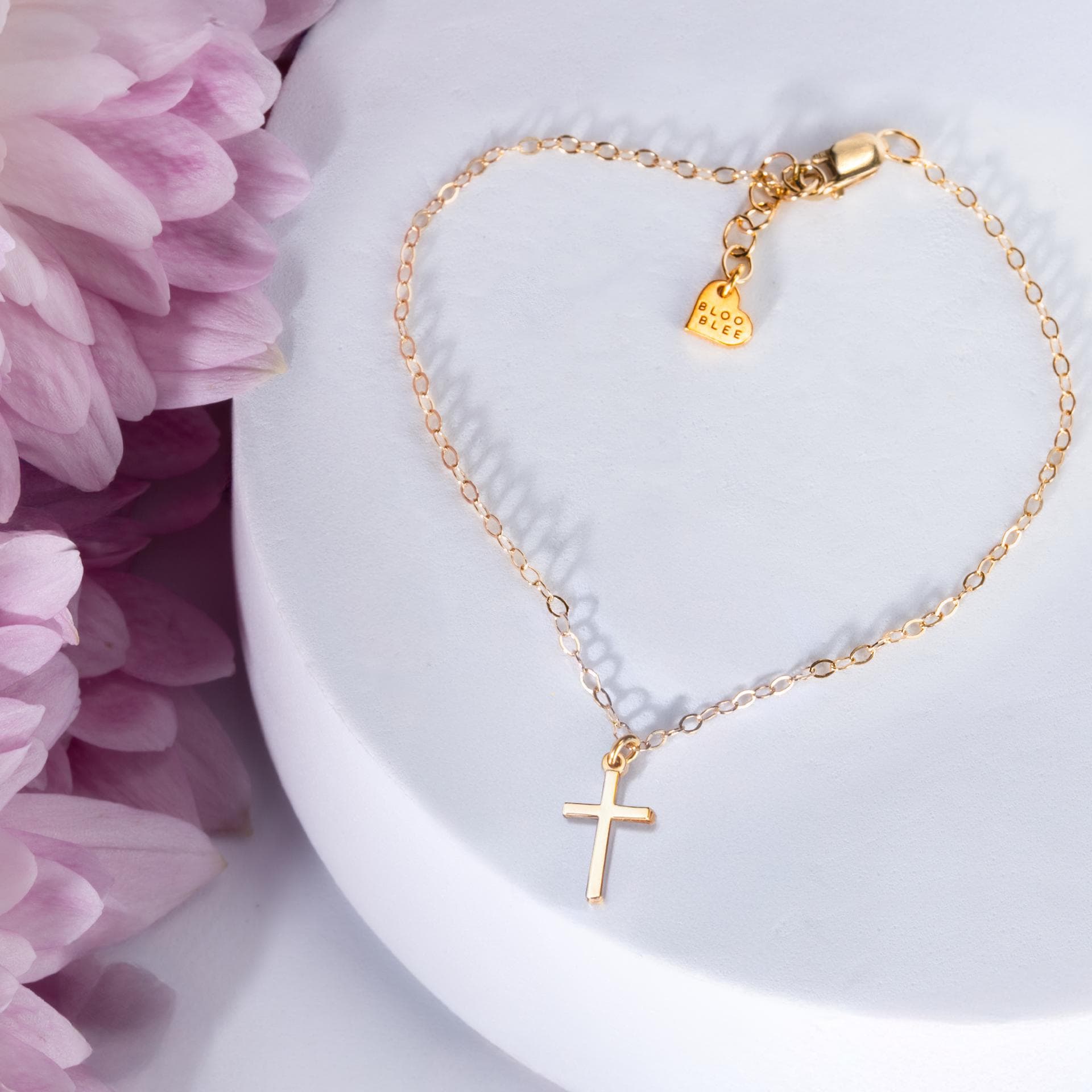 Thin gold cross charm on a fine anklet chain, shown on a white background. (2 of 7)
