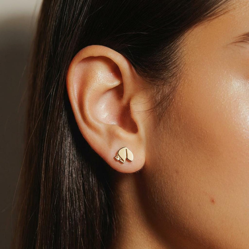 Pair of tiny gold fortune cookie stud earrings with a paper slip detail, on white (2 of 8)