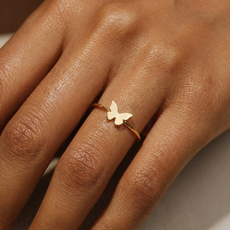 Slim gold band ring with a small flat butterfly on the crown (2 of 11)