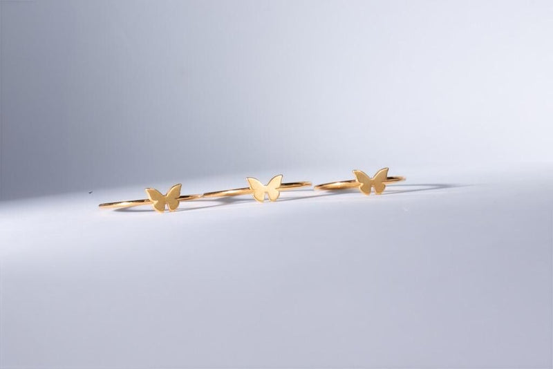 Slim gold band ring with a small flat butterfly on the crown (5 of 11)