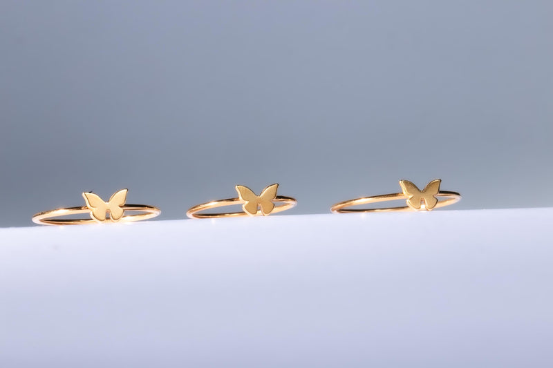 Slim gold band ring with a small flat butterfly on the crown (6 of 11)