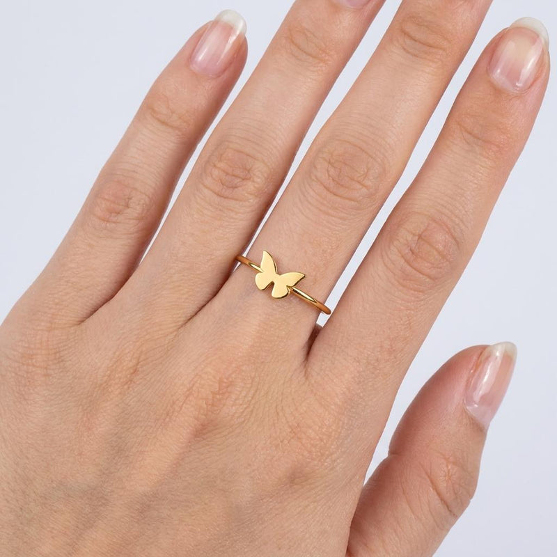 Slim gold band ring with a small flat butterfly on the crown (9 of 11)