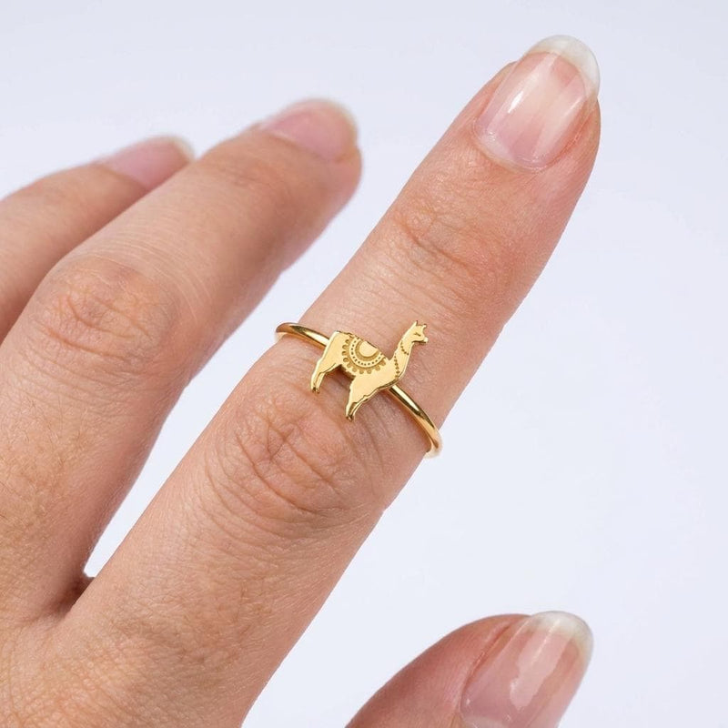 Thin gold stacking ring topped with a small standing llama charm