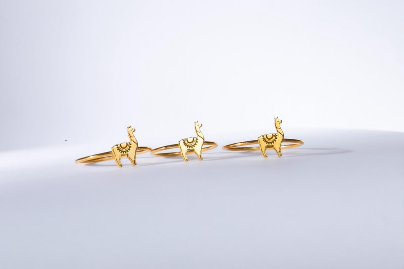 Thin gold stacking ring topped with a small standing llama charm (11 of 13)