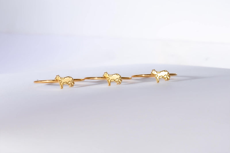 Slim gold stacking ring with a small flat cow design on the top (5 of 9)