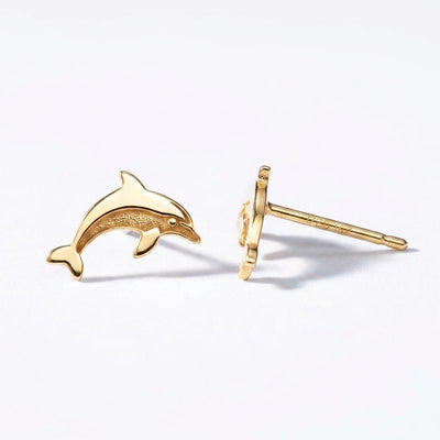 Small gold dolphin stud earrings shown mid leap with tail curved down