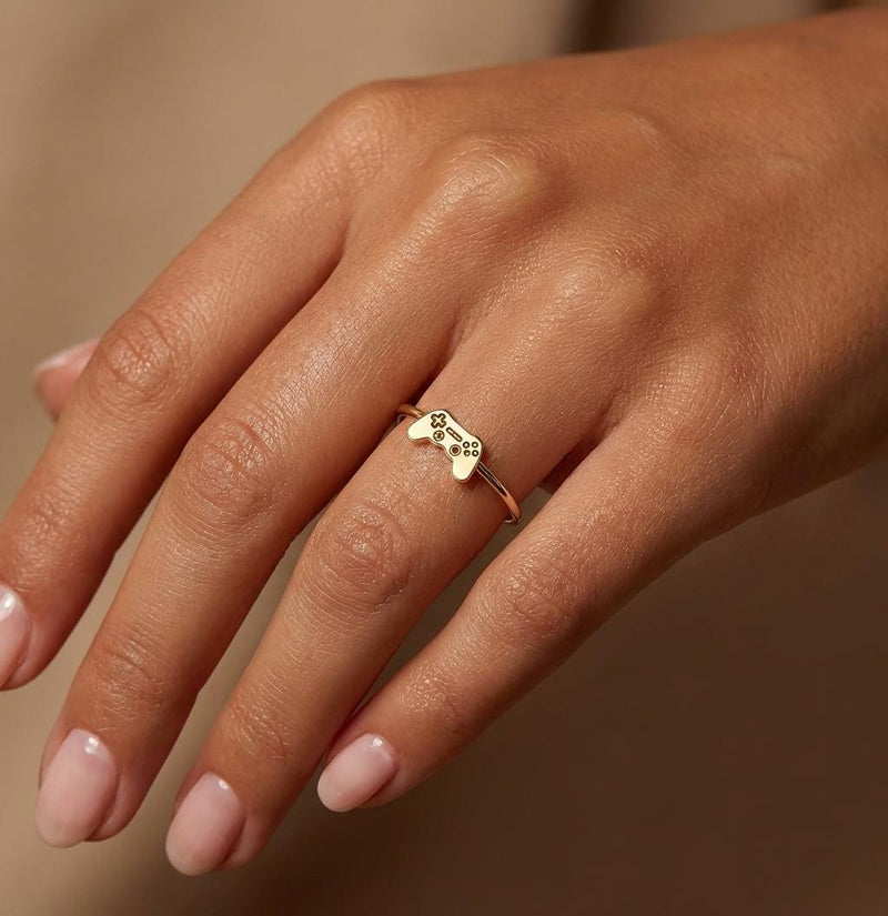 Thin gold ring with a small video game controller shape on the band (3 of 7)