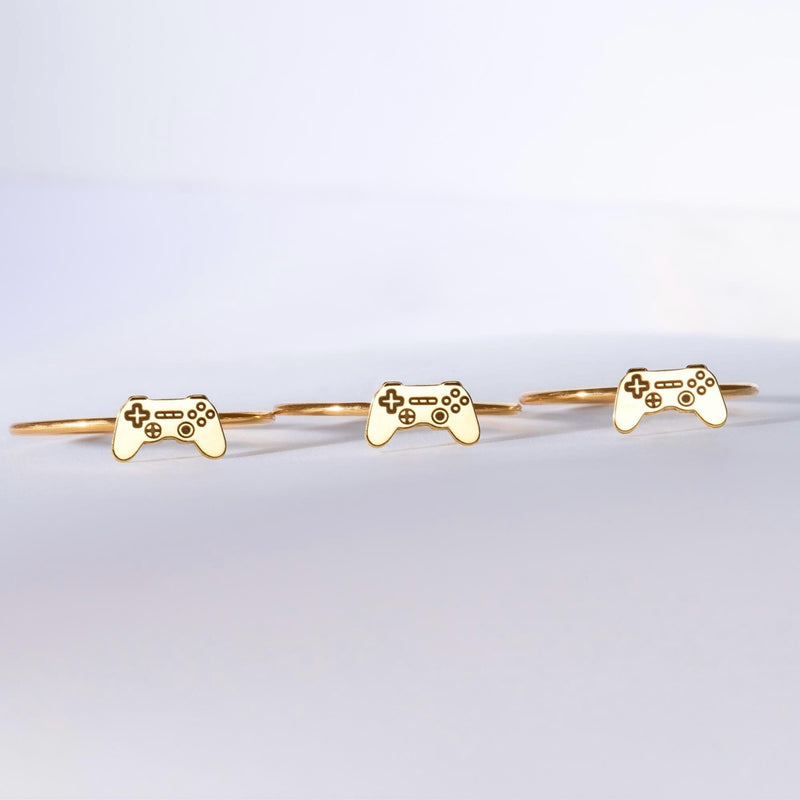 Thin gold ring with a small video game controller shape on the band (5 of 7)