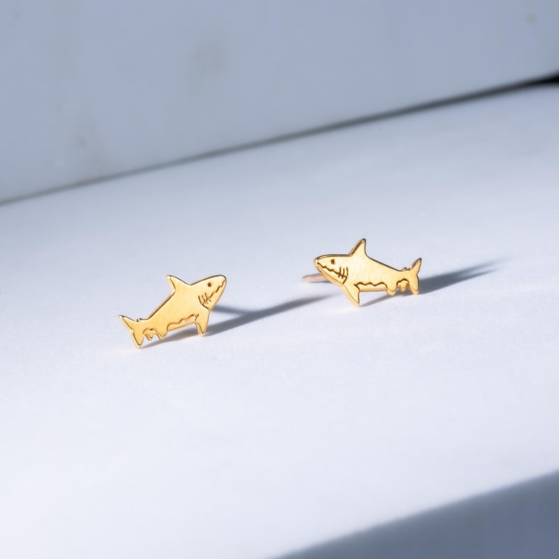 Pair of small shark stud earrings in gold with dorsal fin and curved tail (10 of 14)