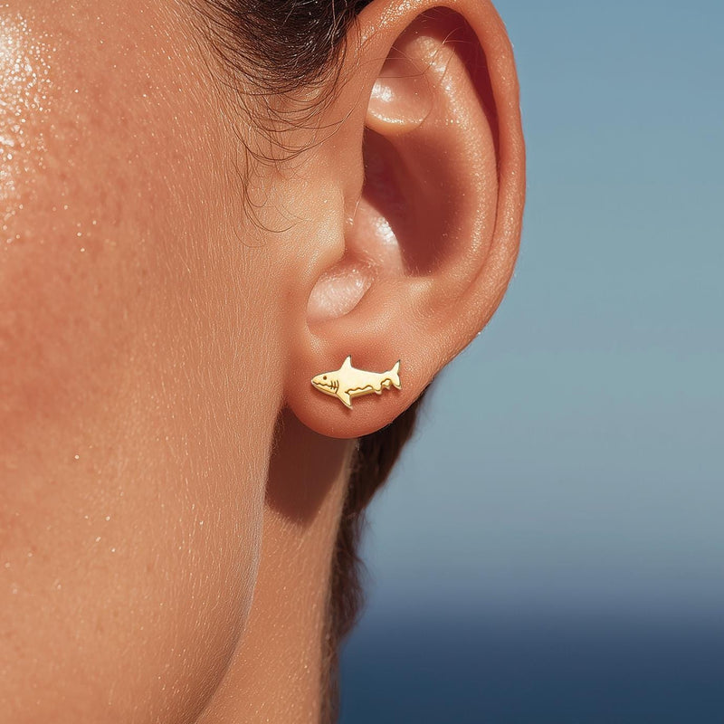 Pair of small shark stud earrings in gold with dorsal fin and curved tail (2 of 14)