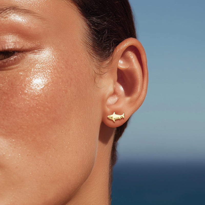 Pair of small shark stud earrings in gold with dorsal fin and curved tail (3 of 14)