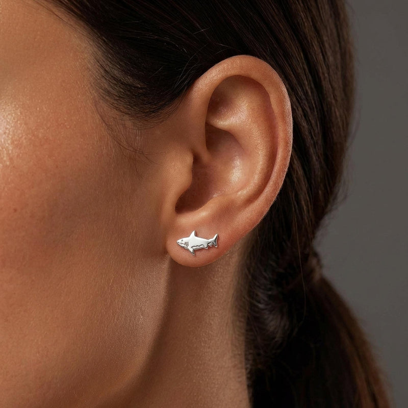 Pair of small shark stud earrings in gold with dorsal fin and curved tail (6 of 14)