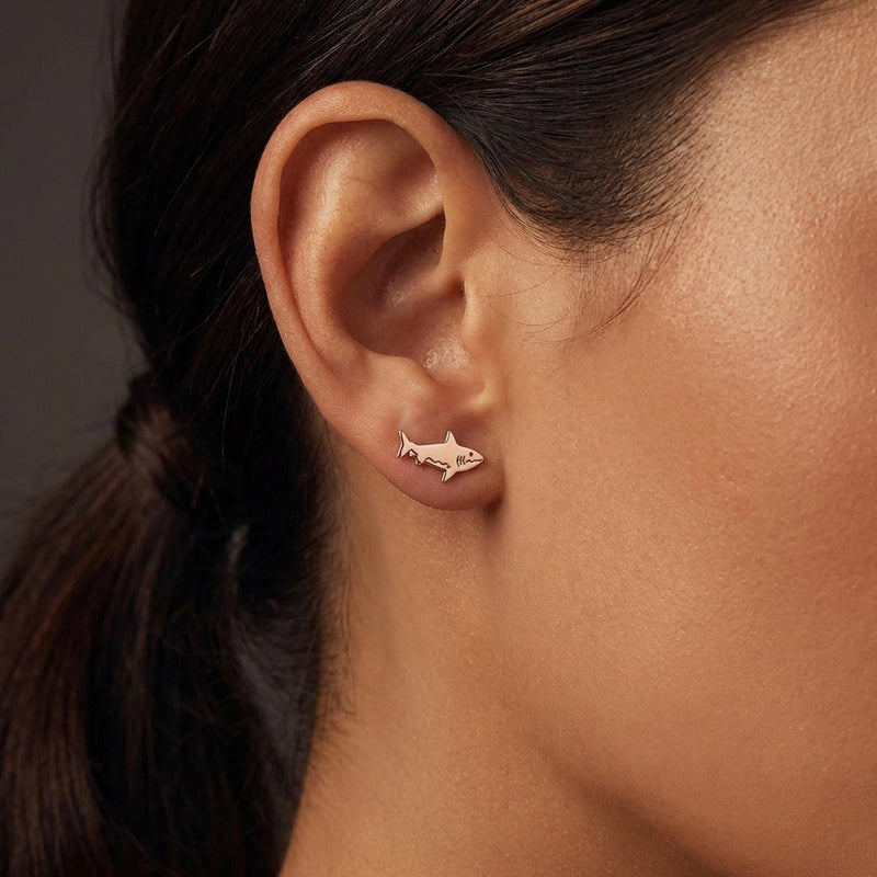 Pair of small shark stud earrings in gold with dorsal fin and curved tail (9 of 14)