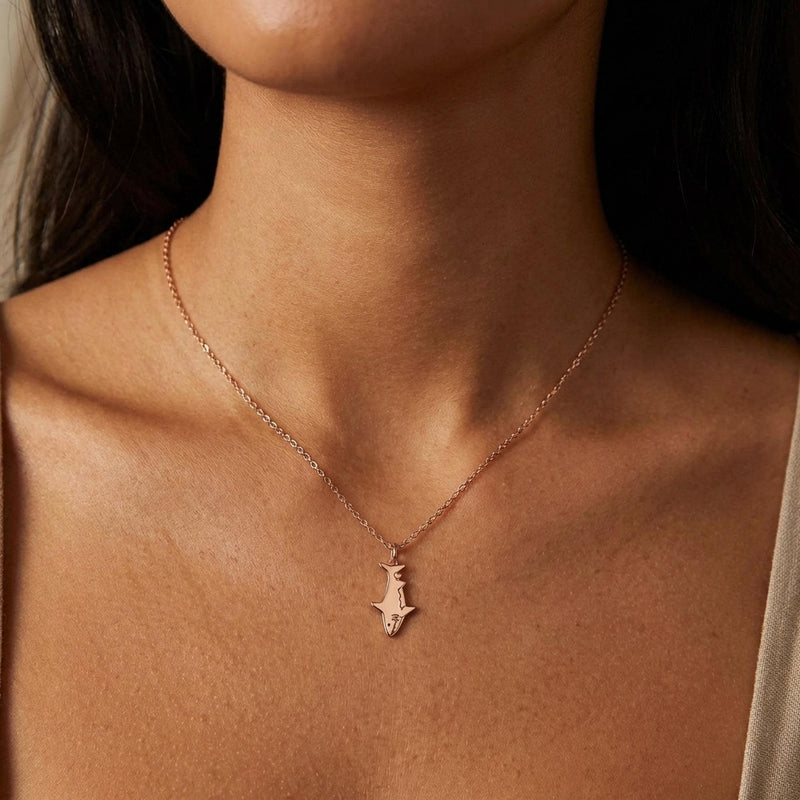 Fine gold chain necklace with a small shark pendant shown in profile (8 of 9)