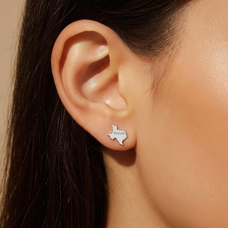 Pair of small gold stud earrings shaped like the state of Texas. (3 of 9)