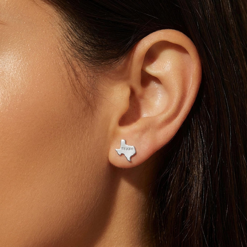 Pair of small gold stud earrings shaped like the state of Texas. (5 of 9)