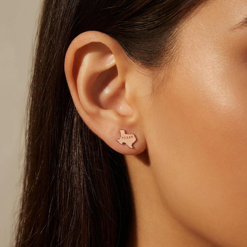 Pair of small gold stud earrings shaped like the state of Texas. (6 of 9)
