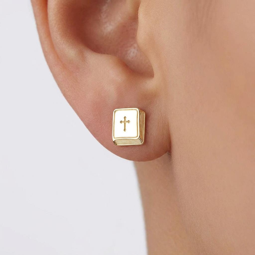 Pair of tiny gold bible stud earrings shown on a plain background (2 of 6)