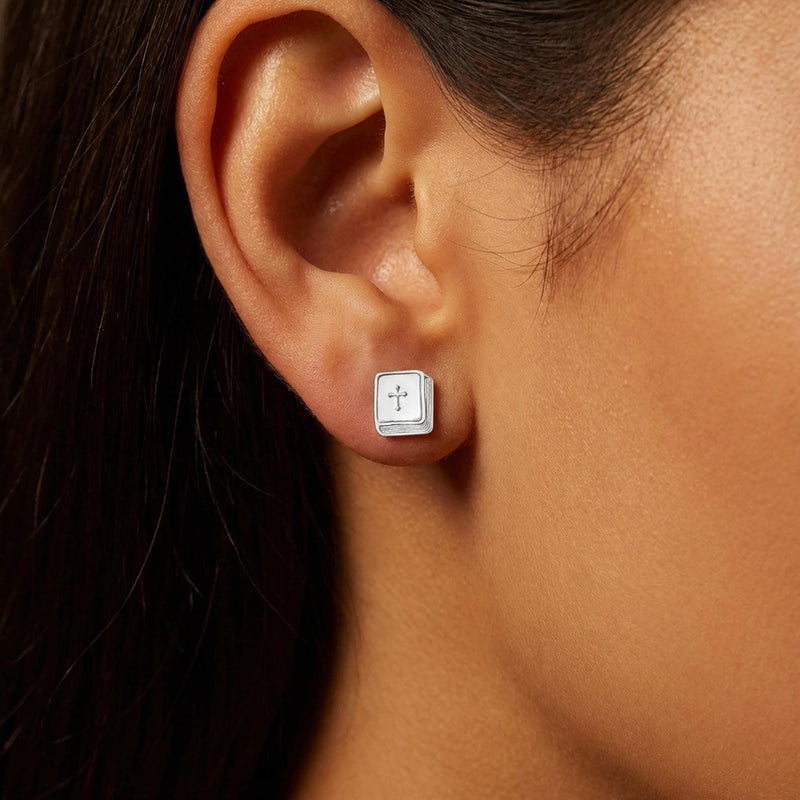 Pair of tiny gold bible stud earrings shown on a plain background (3 of 6)