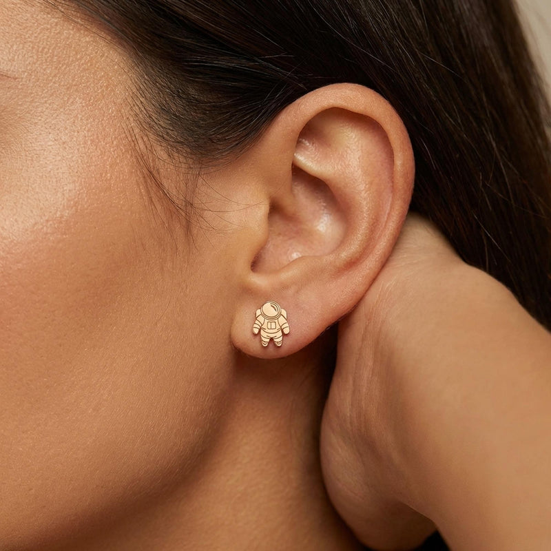 Pair of small gold astronaut stud earrings shown front on (12 of 14)