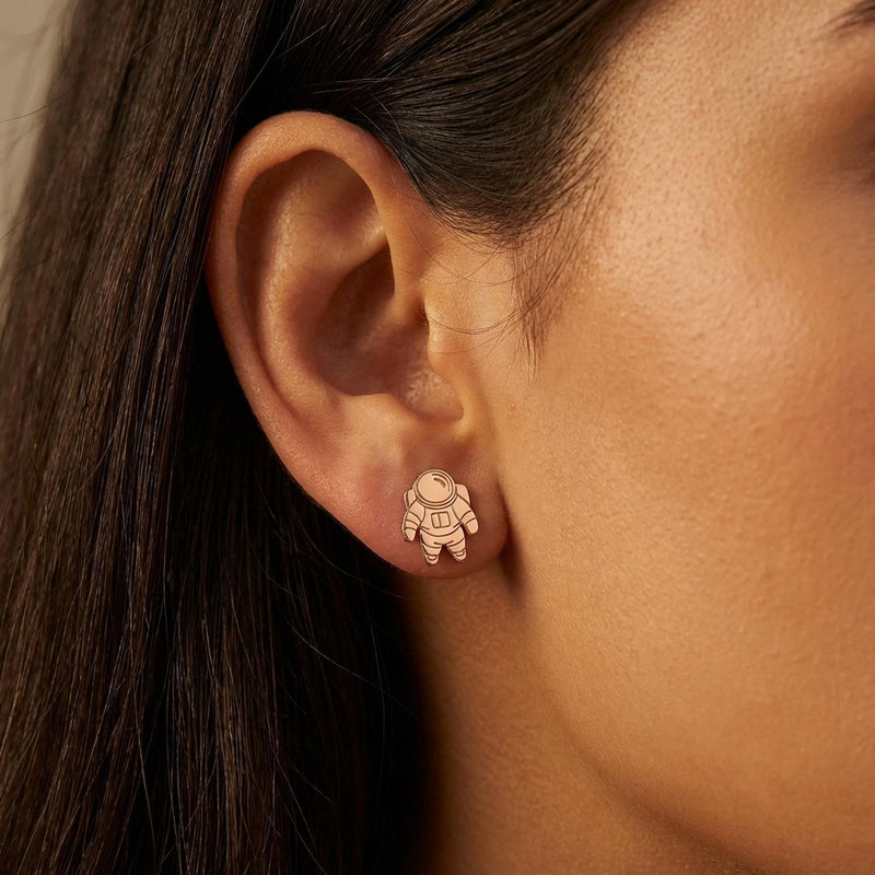 Pair of small gold astronaut stud earrings shown front on (13 of 14)