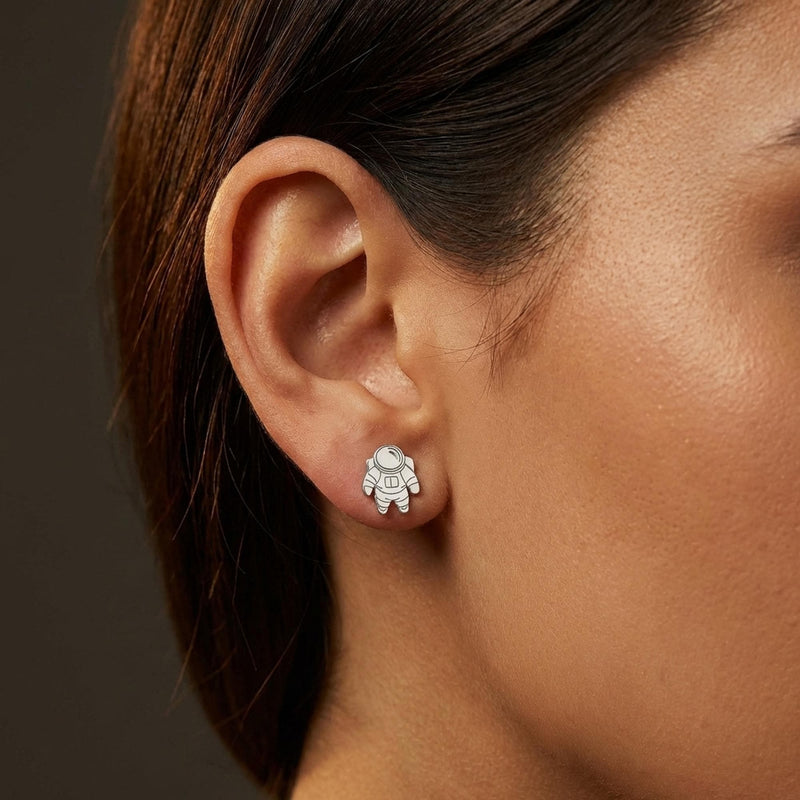 Pair of small gold astronaut stud earrings shown front on (14 of 14)