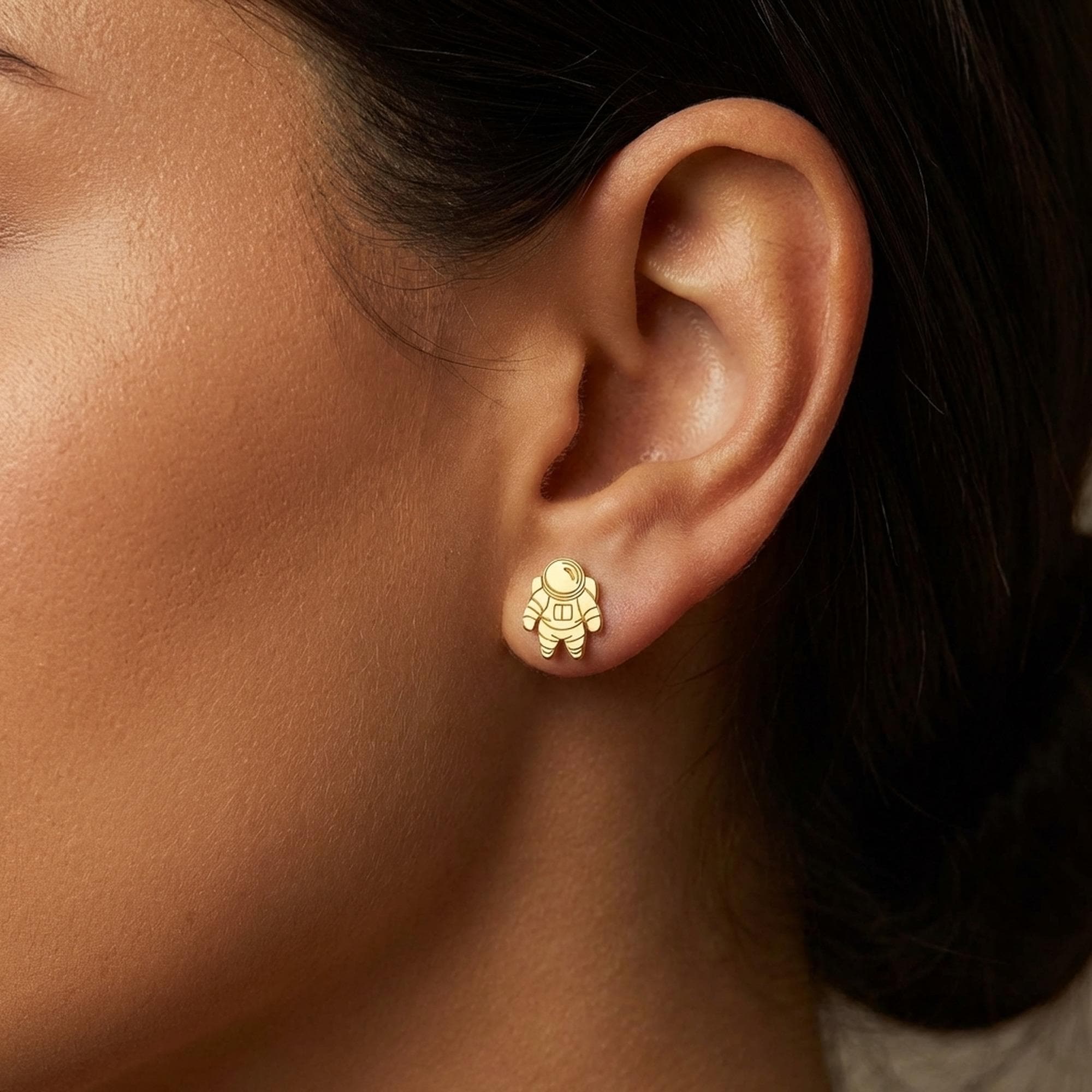 Pair of small gold astronaut stud earrings shown front on (2 of 14)