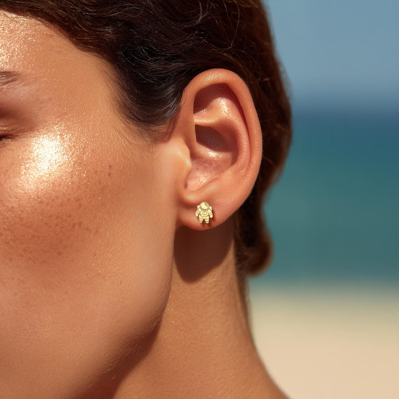 Pair of small gold astronaut stud earrings shown front on (7 of 14)