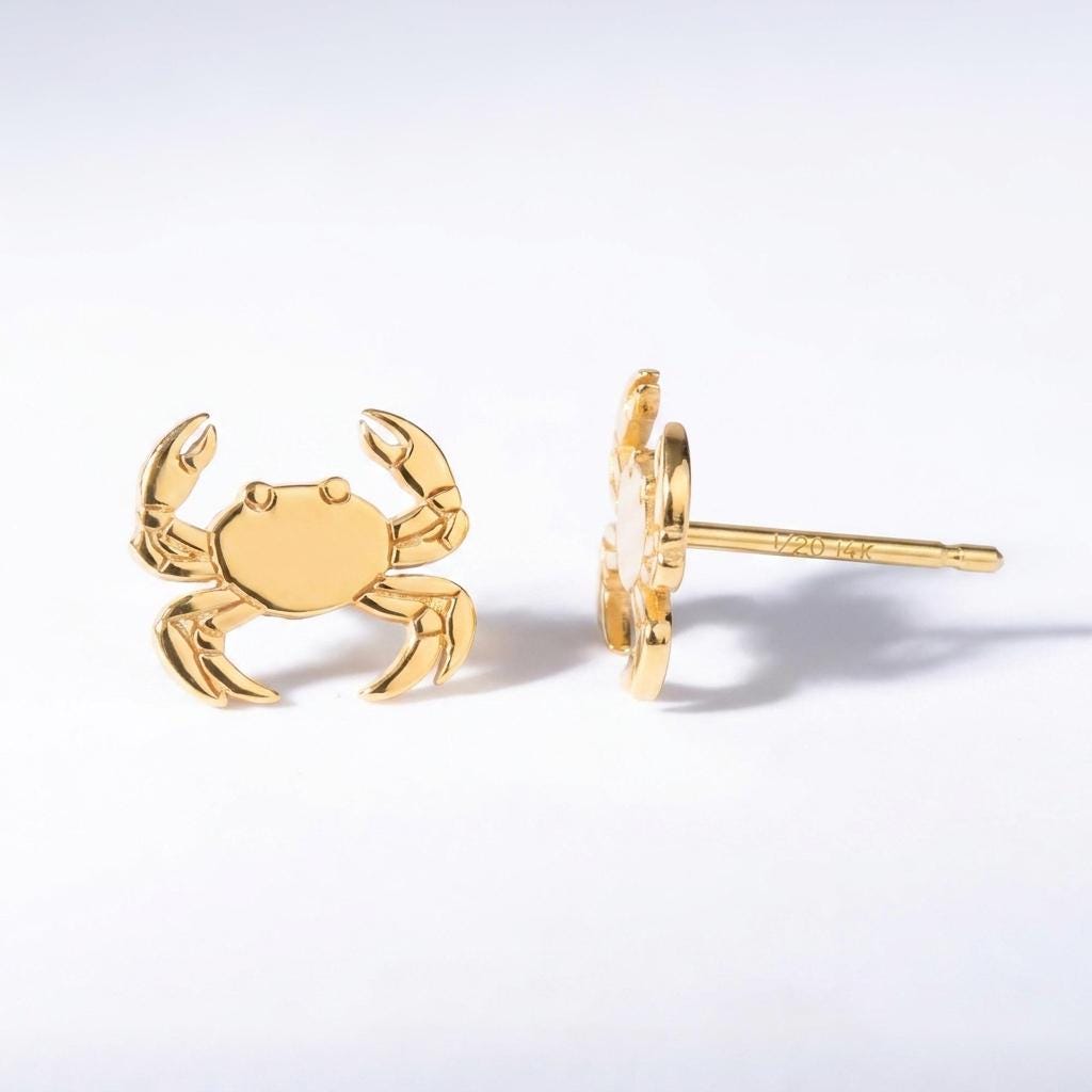 Pair of small gold crab stud earrings with wide claws and eight legs
