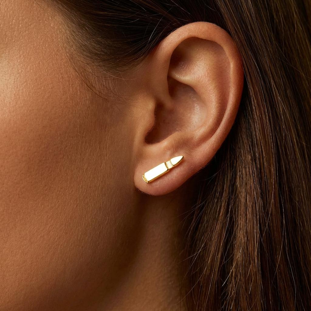 Pair of narrow gold bullet stud earrings shown vertically on a white background (2 of 8)
