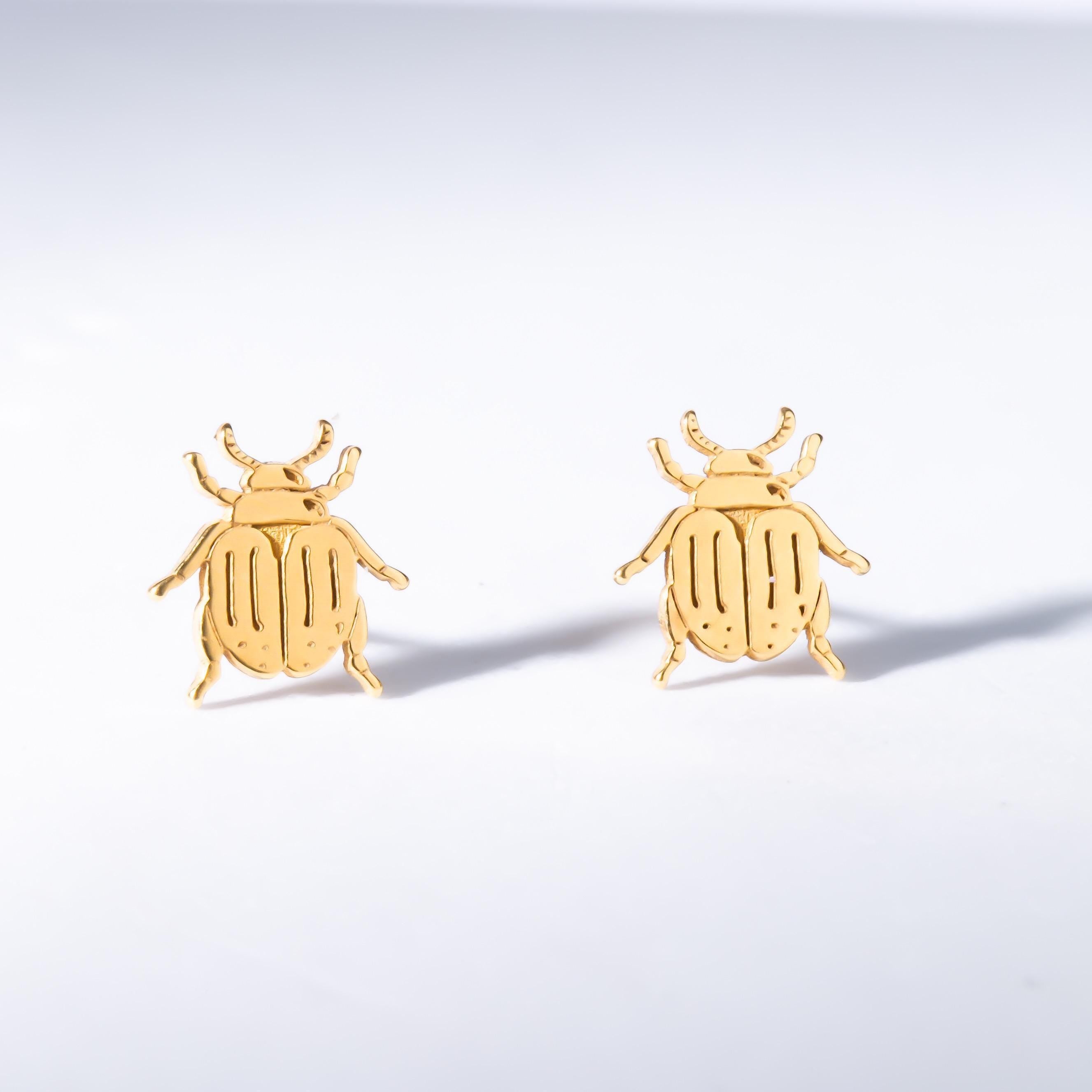Pair of gold scarab beetle stud earrings seen from above. (2 of 9)