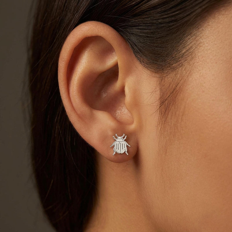 Pair of gold scarab beetle stud earrings seen from above. (8 of 9)