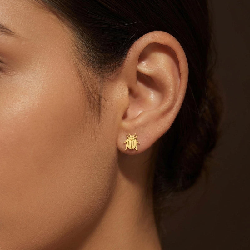 Pair of gold scarab beetle stud earrings seen from above. (9 of 9)
