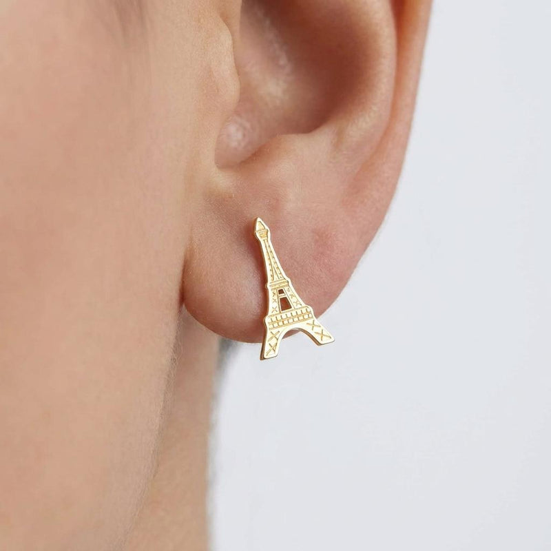 Pair of small gold Eiffel Tower stud earrings with open lattice detail.