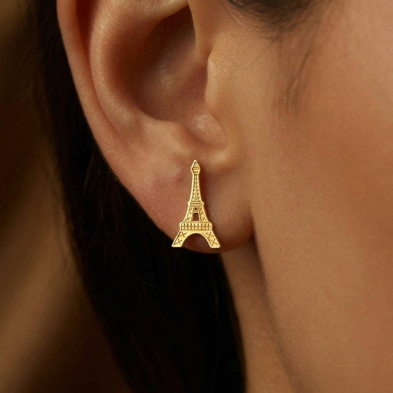 Pair of small gold Eiffel Tower stud earrings with open lattice detail. (2 of 8)