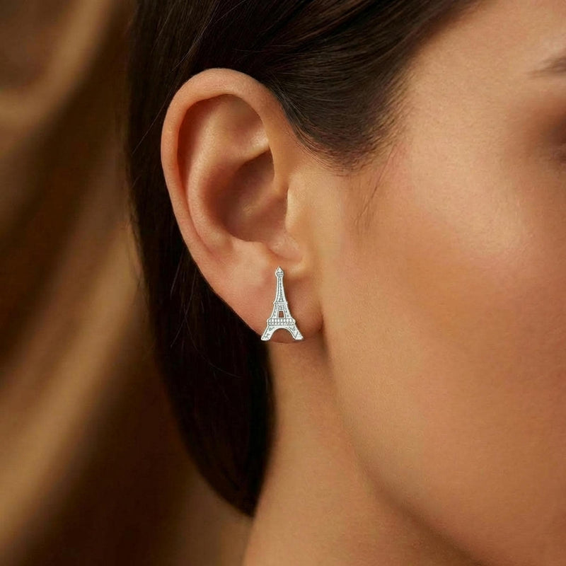 Pair of small gold Eiffel Tower stud earrings with open lattice detail. (4 of 8)