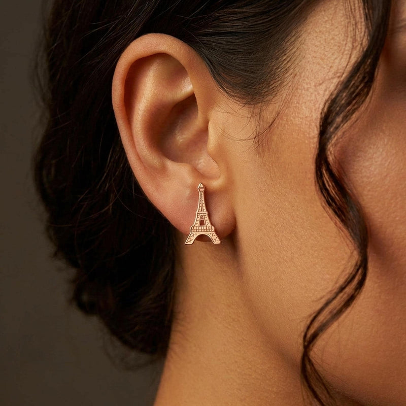 Pair of small gold Eiffel Tower stud earrings with open lattice detail. (5 of 8)