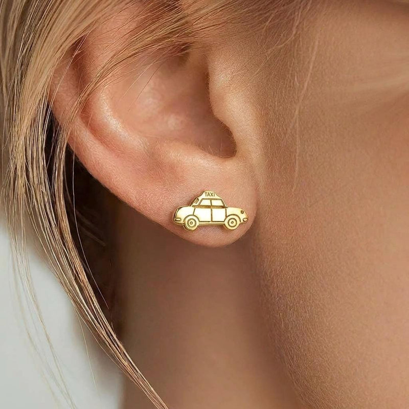 Pair of gold taxi cab stud earrings shown in profile with a roof light