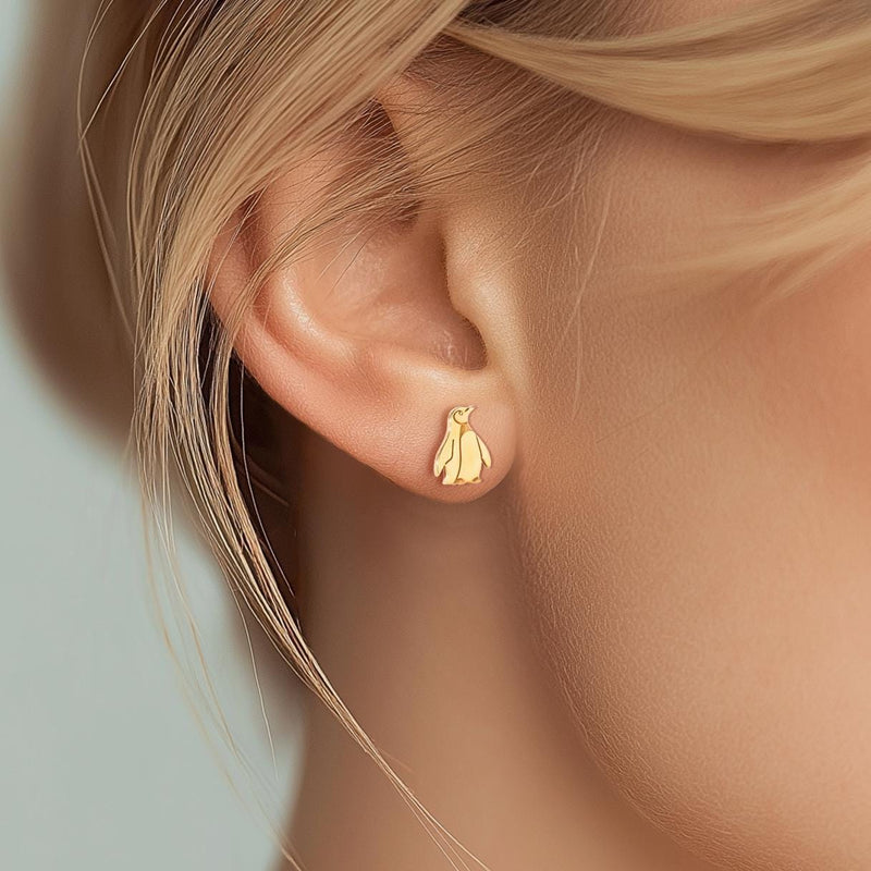 Pair of small gold penguin stud earrings with short flippers and a belly panel. (12 of 12)
