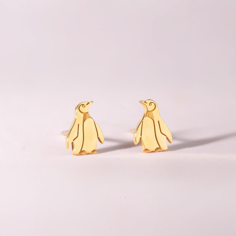 Pair of small gold penguin stud earrings with short flippers and a belly panel. (3 of 12)