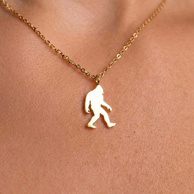 Fine gold chain necklace with a small walking Bigfoot sasquatch pendant